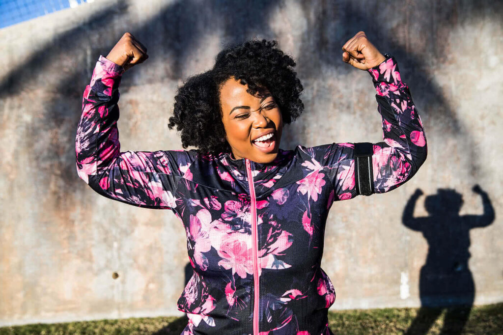 Woman celebrating weight loss to help in her prevention of diabetes.