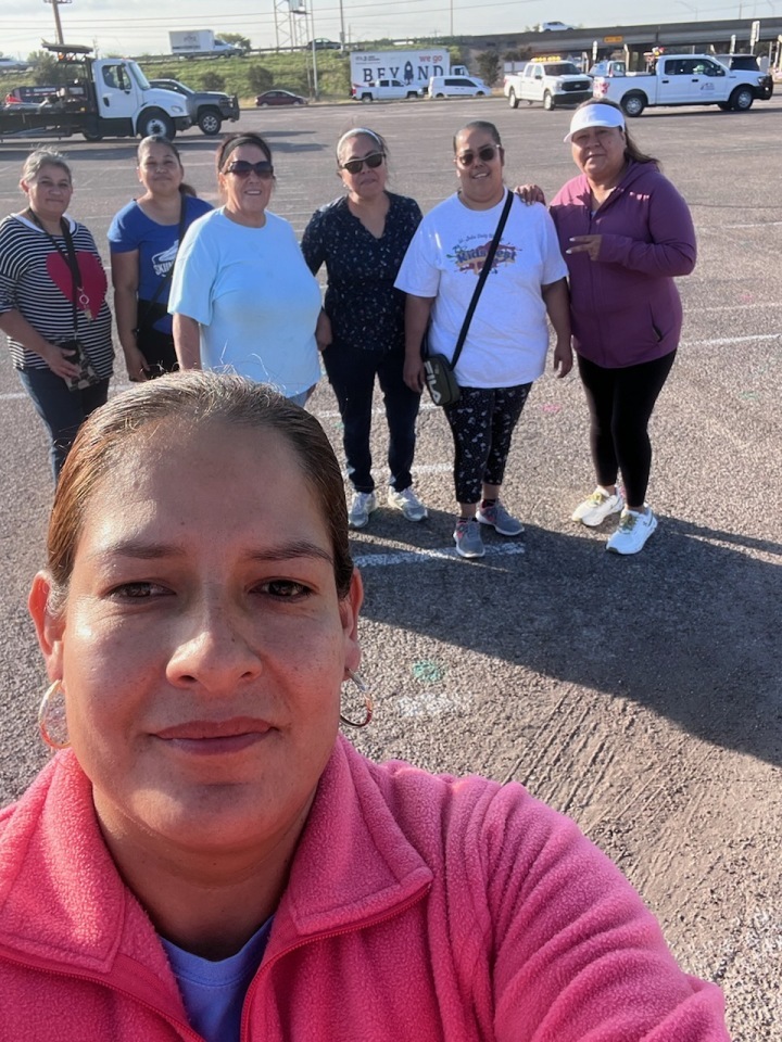 Group of Latina women outside on a walk, smiling.